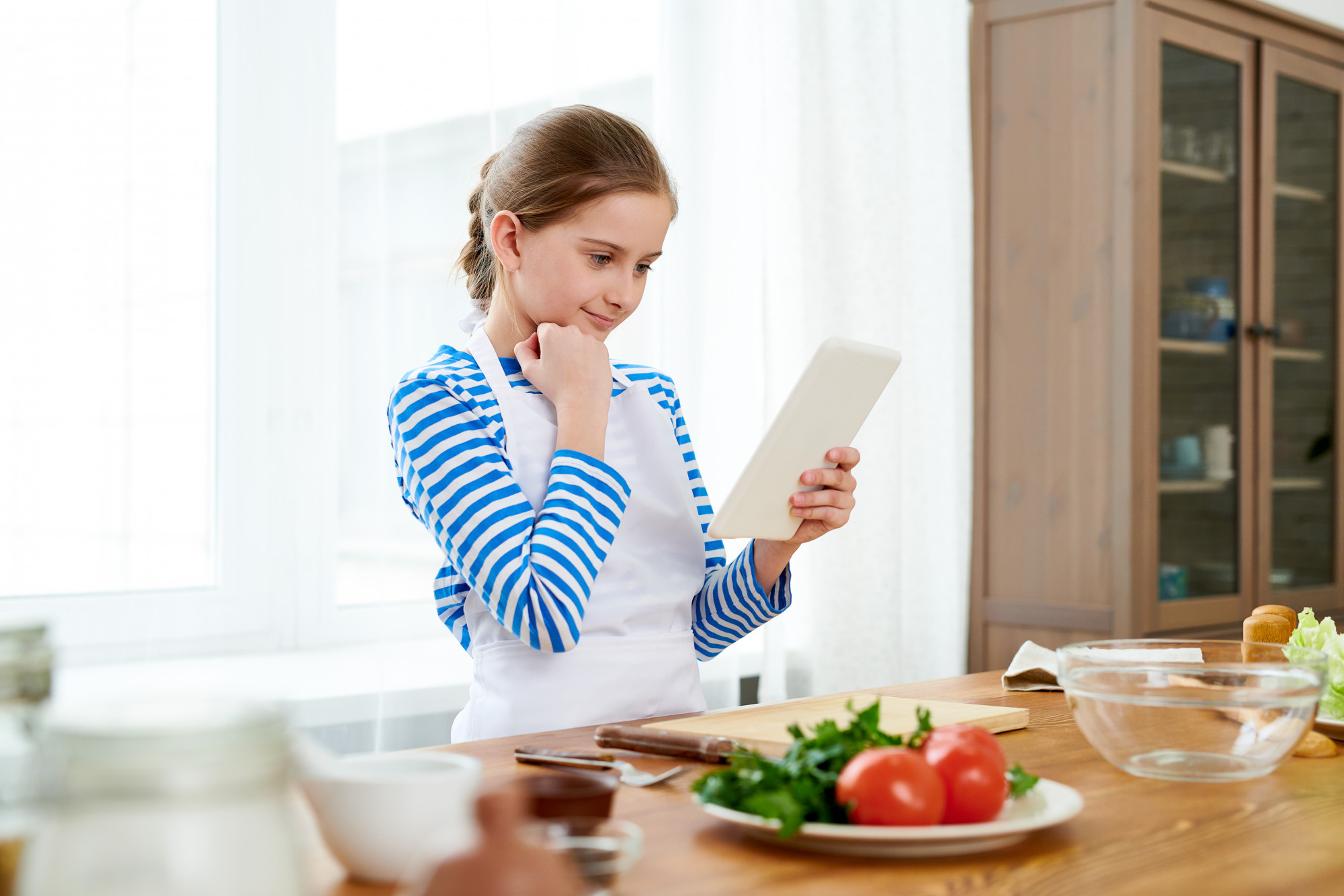 User following tablet recipe in kitchen